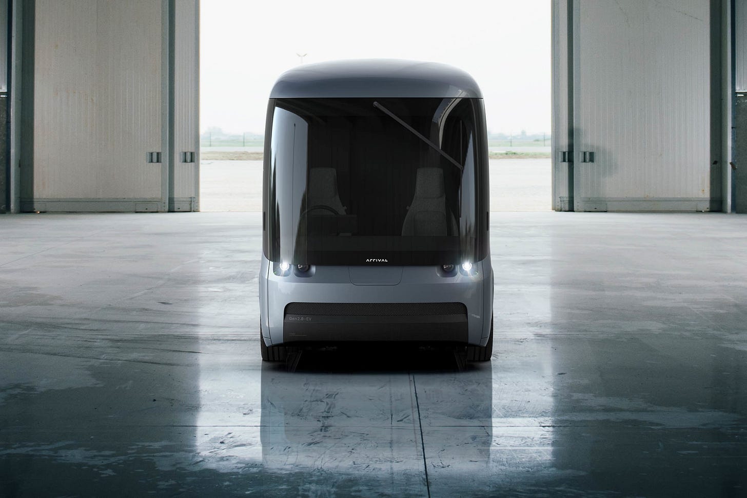 Front view of an electric van in a large hangar 