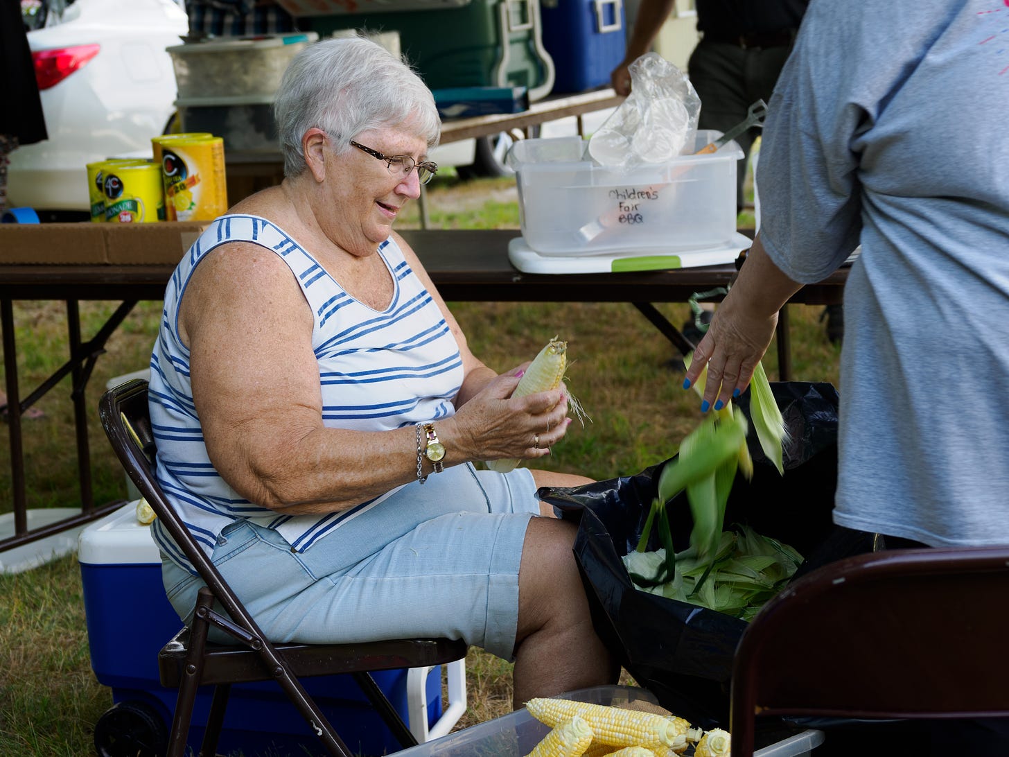 Woman shucking corn