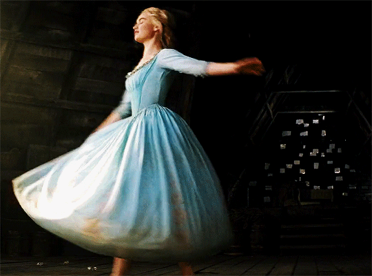 A woman twirling in a blue dress