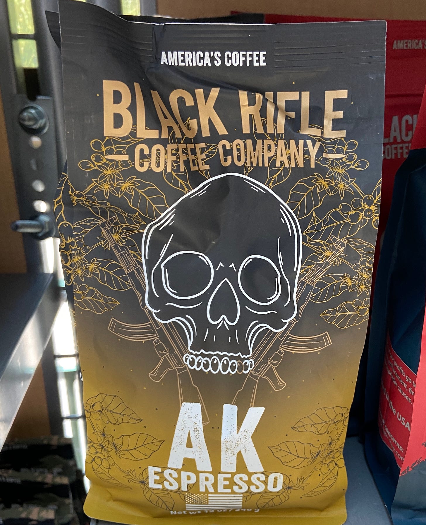 A coffee bag with a skull and AK-47 assault rifles, with the title "AK Espresso"