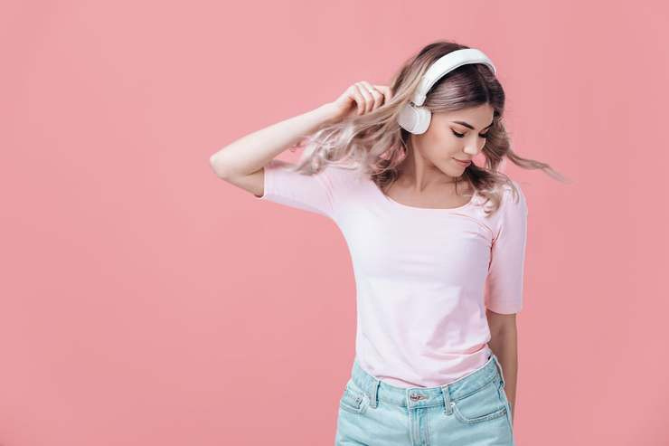 A young woman listening to music with headphones on