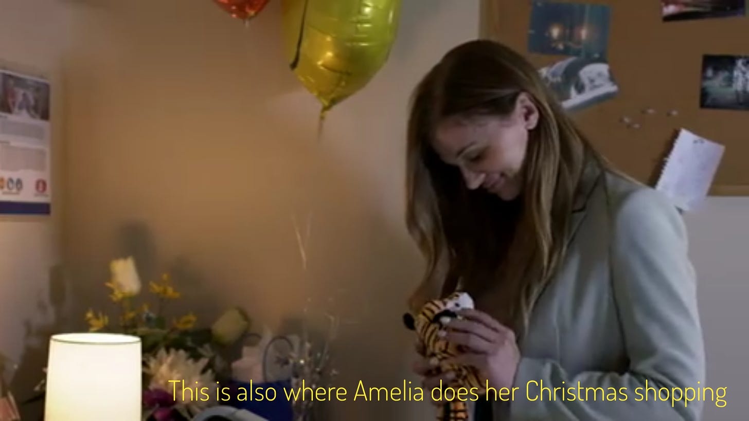 Amelia, a thin white woman with long brown hair, holding a small stuffed tiger in a hospital room, captioned "This is also where Amelia does her Christmas shopping"