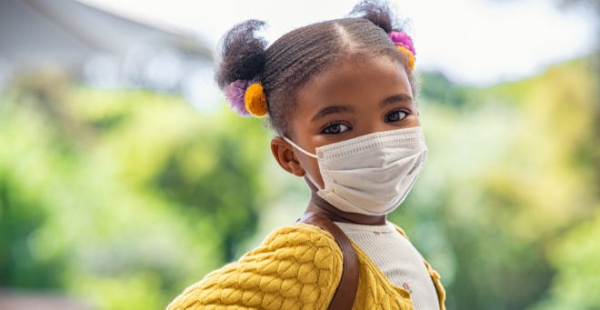 Girl wearing a mask outside