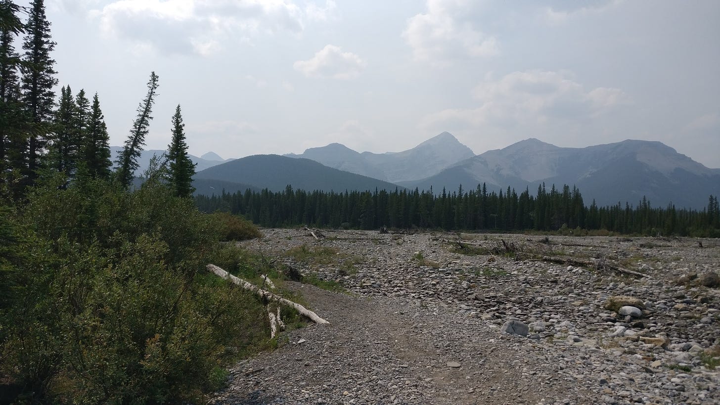 View of Little Elbow Creek, with the Rockies obscured by smoke in the distance, near Bragg Creek Alberta