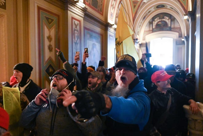 Supporters of US President Donald Trump protest inside the US Capitol on January 6, 2021, in Washington, DC. - Demonstrators breeched security and entered the Capitol as Congress debated the a 2020 presidential election Electoral Vote Certification. (Photo by ROBERTO SCHMIDT / AFP)