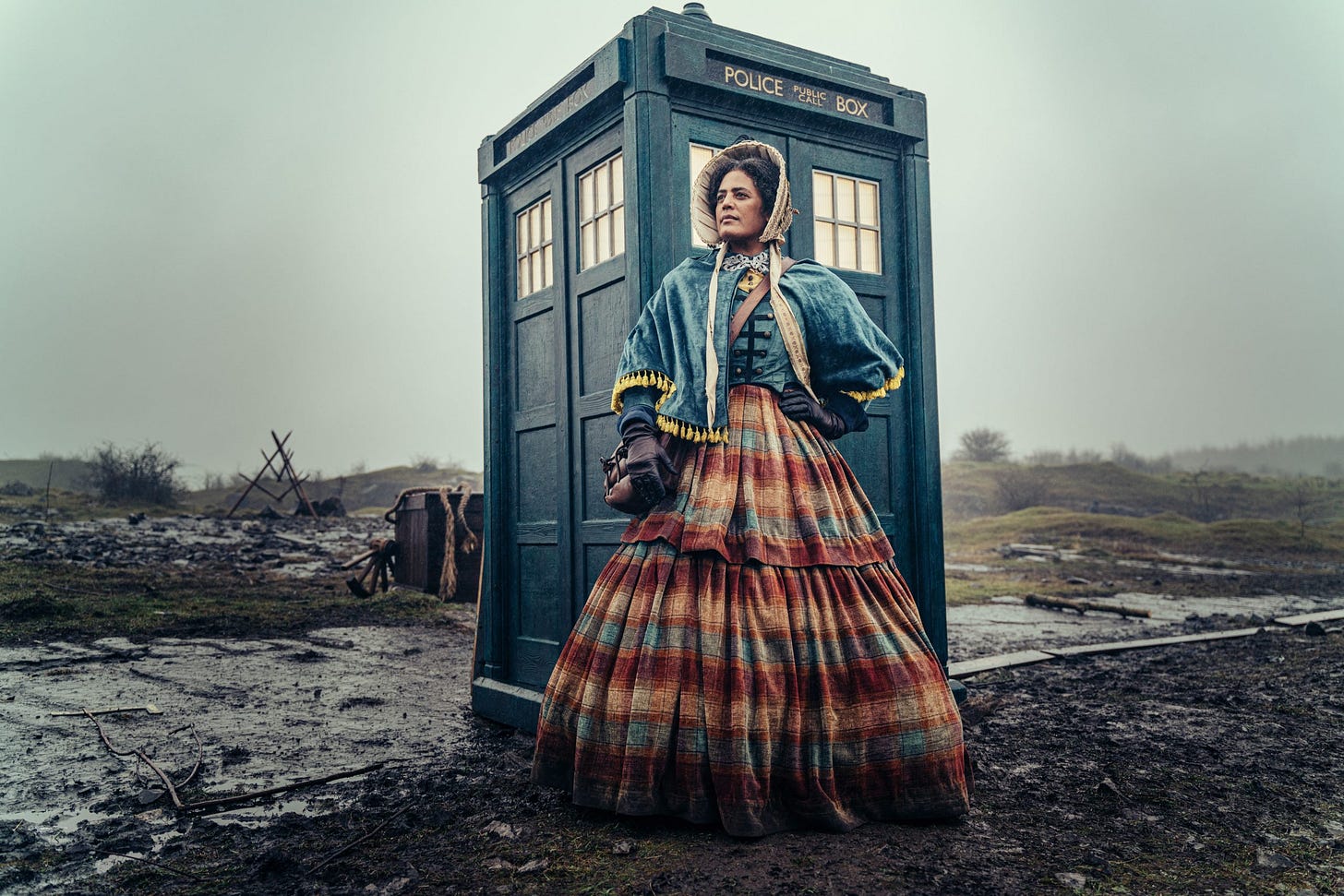 This image shows the character Mrs. Mary Seacole (played by Sara Powell) standing in front of the TARDIS, which itself rests on a forlorn battlefield in Sevastopol, Crimea circa 1855. This image shows the character Mrs. Mary Seacole (played by Sara Powell) standing in front of the TARDIS, which itself rests on a forlorn battlefield in Sevastopol, Crimea circa 1855.