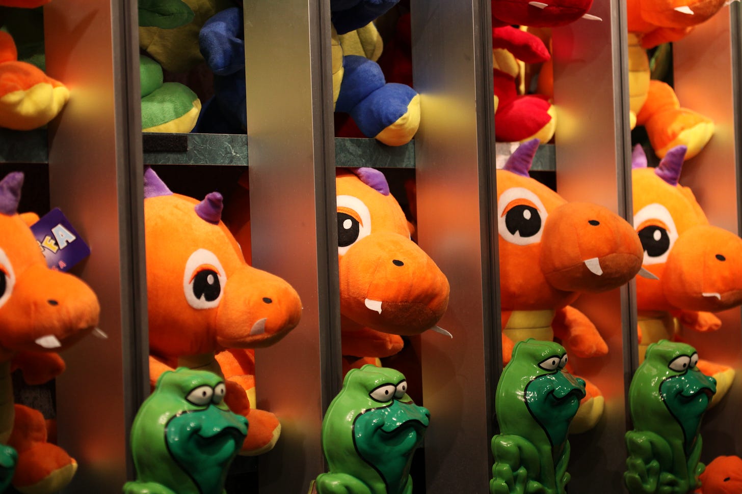 A series of stuffed animals in rows.