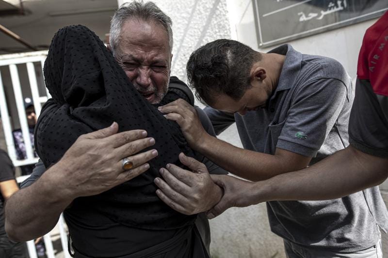 Relatives of Muhammad Hassouna, who was killed in an Israeli airstrike mourn before his funeral outside a hospital in Rafah, in the southern Gaza Strip, Sunday, Aug. 7, 2022. An Israeli airstrike in Rafah killed a senior commander in the Palestinian militant group Islamic Jihad, authorities said Sunday, its second leader to be slain amid an escalating cross-border conflict. (AP Photo/Fatima Shbair)