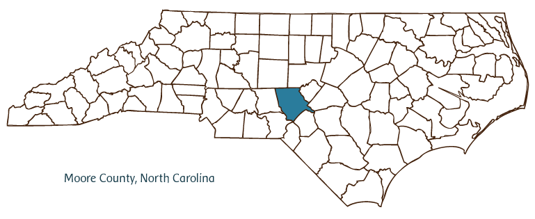 A map outlining the counties in North Carolina.  Moore County is highlighted in blue in the center-bottom of the map.