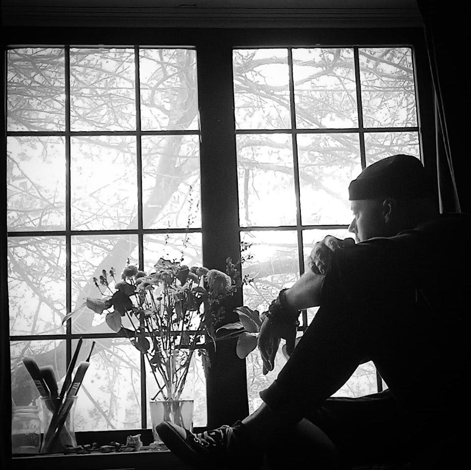 Jeffrey Puukka, a theatre director and acting coach sits at a window sill looking out at a tree.  Image from the fourth article of THOUGHT BUBBLES, by Jeffrey Puukka.