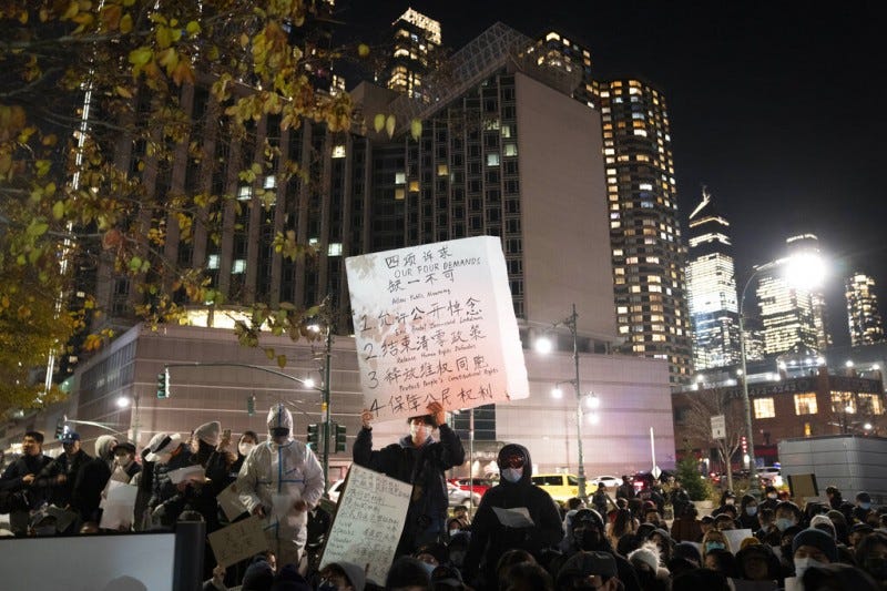 2022年11月29日，中國駐紐約總領事館外有許多人聲援「白紙革命」、高呼「打倒習近平」，並且高舉「四項訴求，缺一不可」的標語。（美聯社）