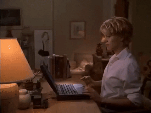 A gif where we pan from Meg Ryan typing in her apartment to Tom Hanks typing in his.