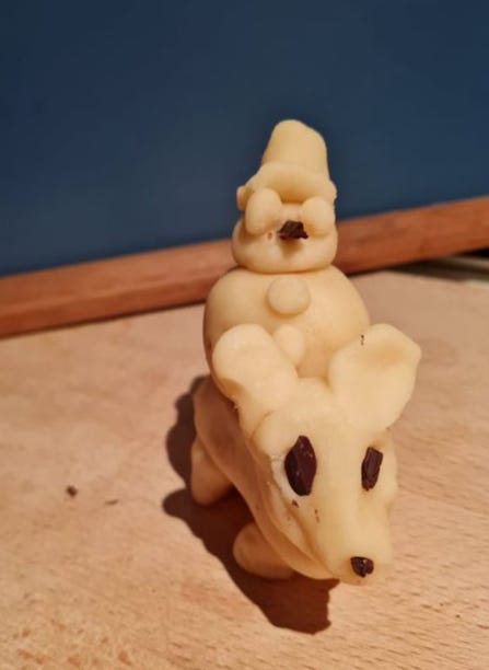 Photo of a marzipan snowman riding a marzipan rat thingie