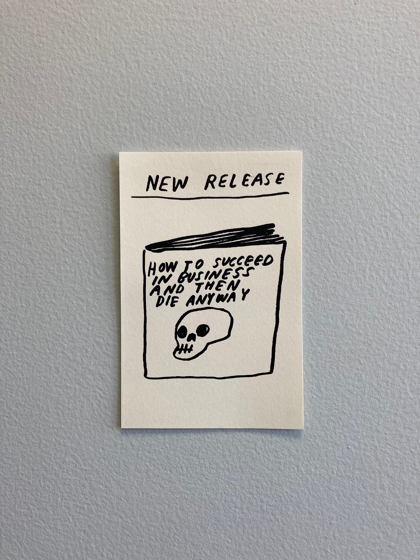 a postcard sketch of a book with a skull on its cover, titled "How To Succeed in Business and Then Die Anyway", by the artist Nat Russell 
