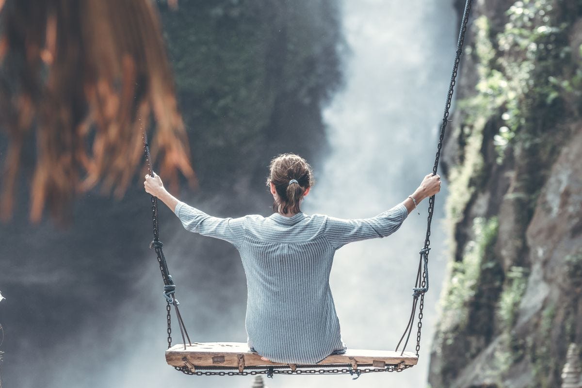 Woman Riding Big Swing in Front of Waterfalls · Free Stock Photo