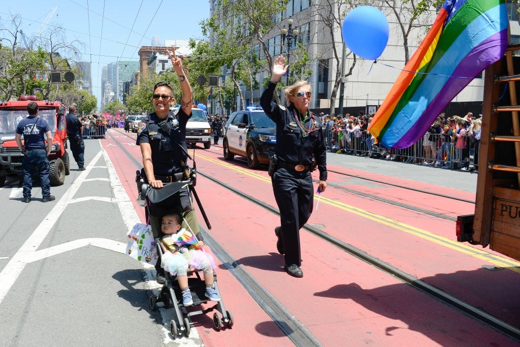 officers marching in pride parade