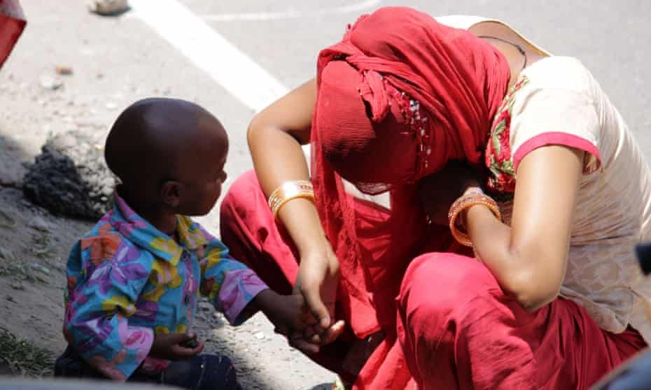 A mother with her child on the street in Uttarakhand.