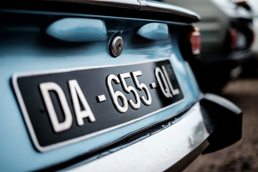 close photo of white and black car license plate