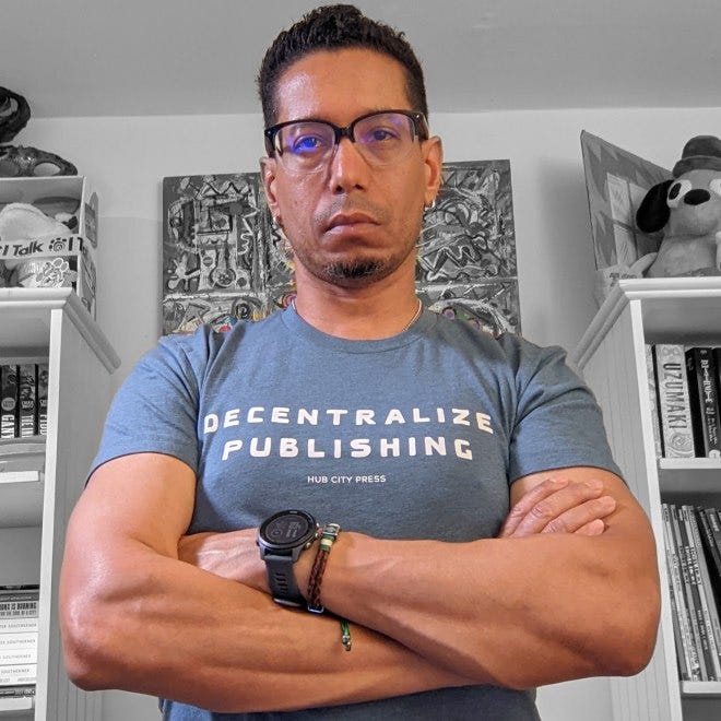 Me, arms crossed, in a "Decentralize Publishing" t-shirt