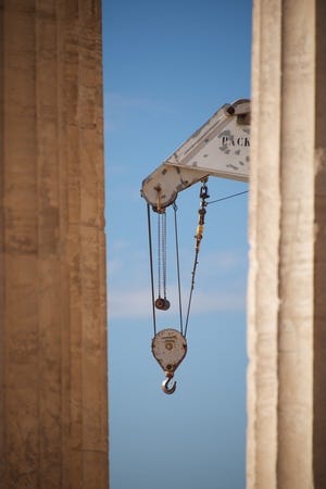 Crane appearing between two marble Parthenon columns.jpg