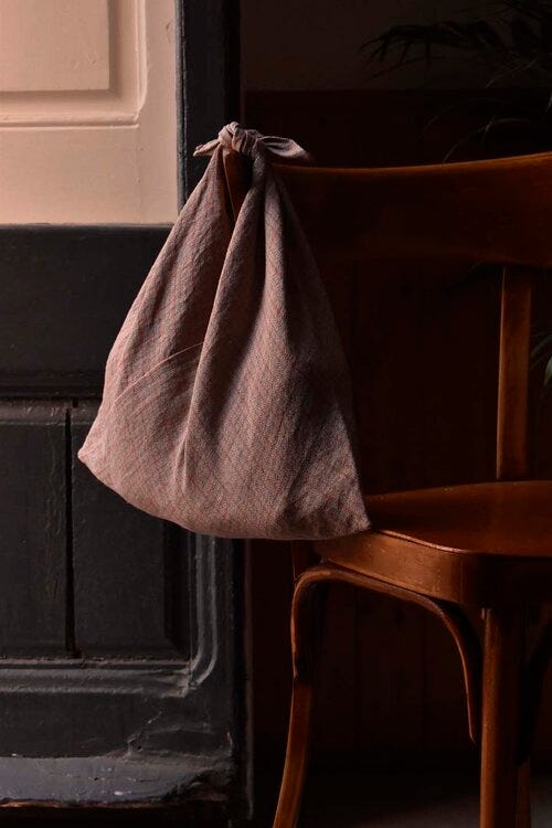 A bag hangs off a chair back