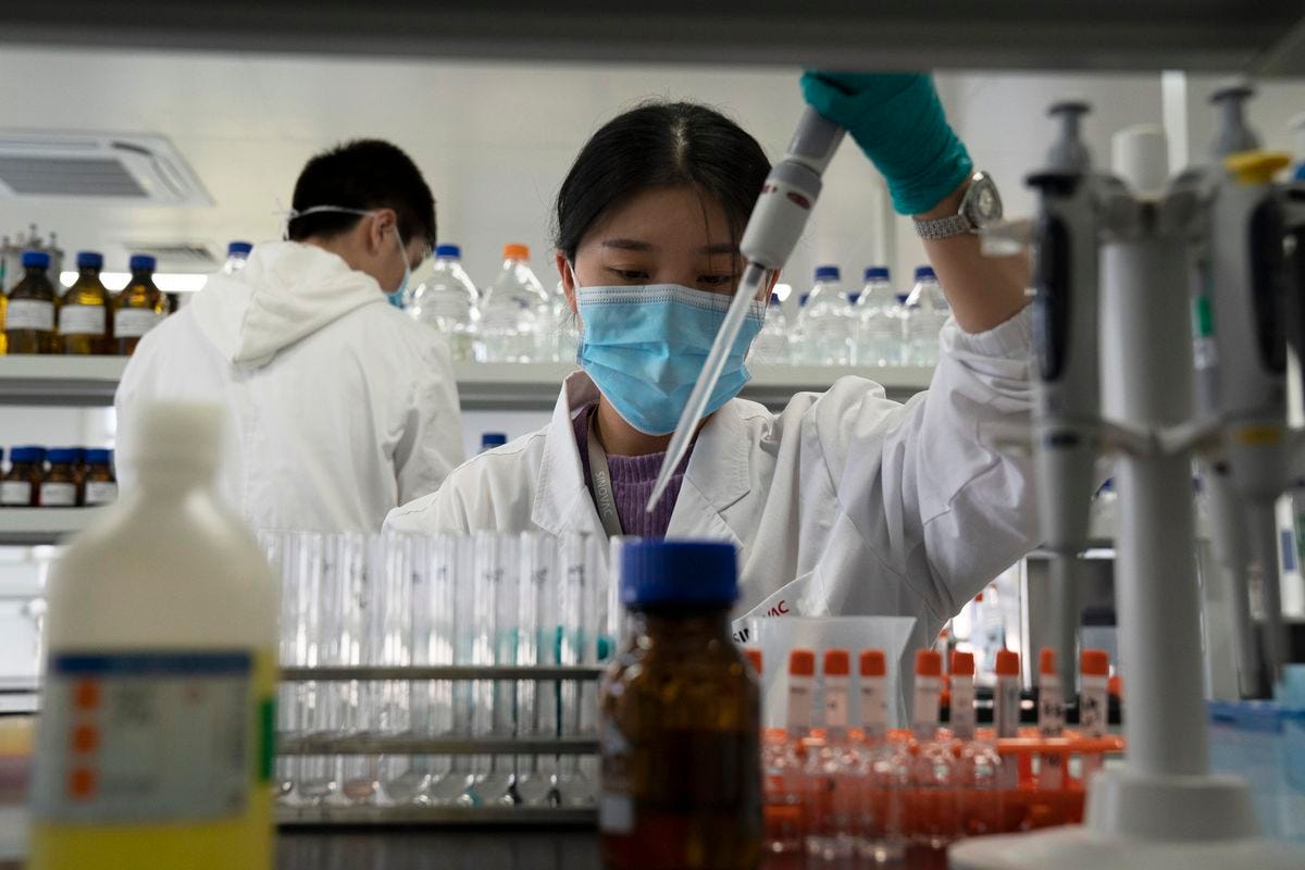 An employee of Sinovac works in a lab at a factory producing its SARS-CoV-2 vaccine for COVID-19 named CoronaVac in Beijing. (AP Photo/Ng Han Guan, File)