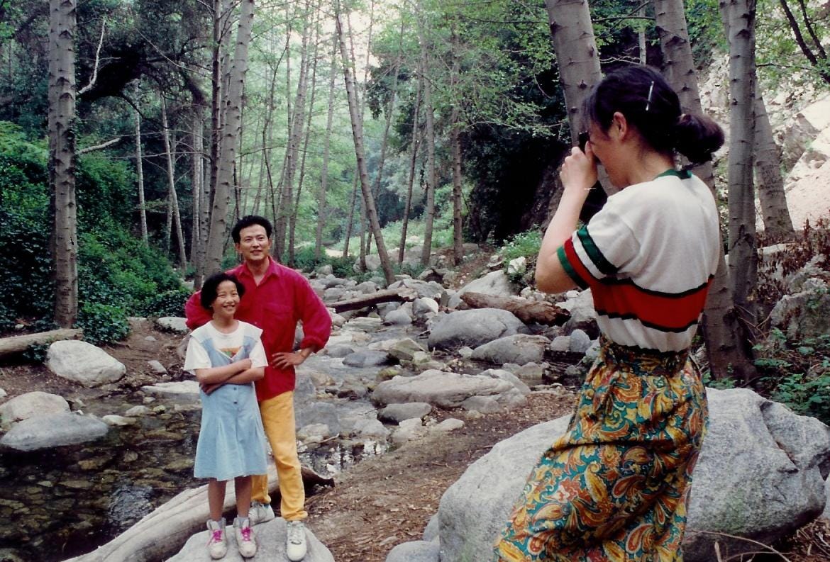 Family in forest by stream