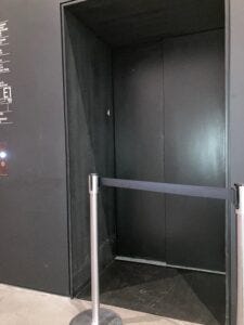 Photo of elevator blocked by poles and webbing.