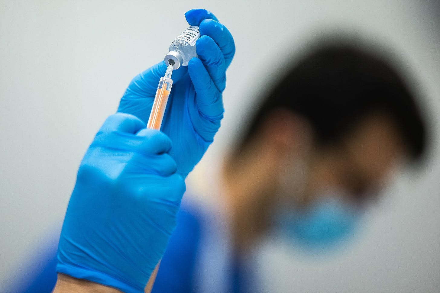 vaccine syringe being filled