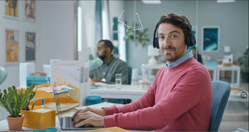 Imagine the smuggest looking white guy, with a raised eyebrow, and designer stubble that can’t quite make a beard that you just KNOW took him three months to grow, wearing a salmon-pink sweater. Of course he’s typing on a MacBook, OF COURSE he is. Dick.
