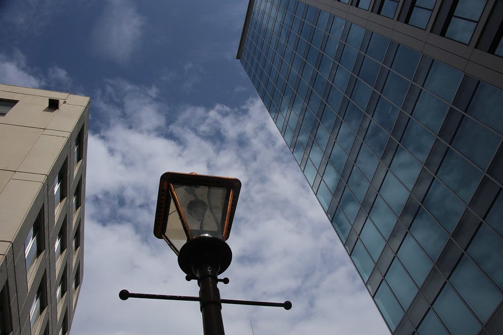 Street light with skyscrapers © Wes Lang