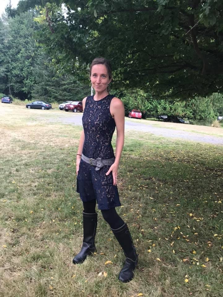 photo of the author wearing a wedding appropriate blue lace dress and inappropriate black rubber boots and a utility belt