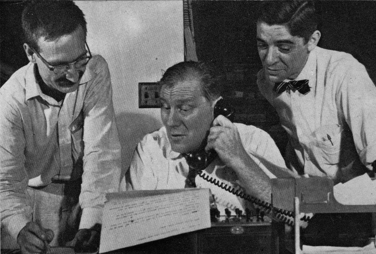 Three reporters at typewriter