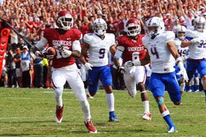 OU's Jaz Reynolds (16) looks for running room as TU's Darnell Walker, Jr. (4) and Dwight Dobbins (9) give chase.  Also pictured:  Jalen Saunders (8)