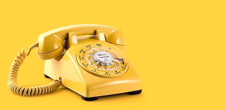 Photo of a yellow dial telephone