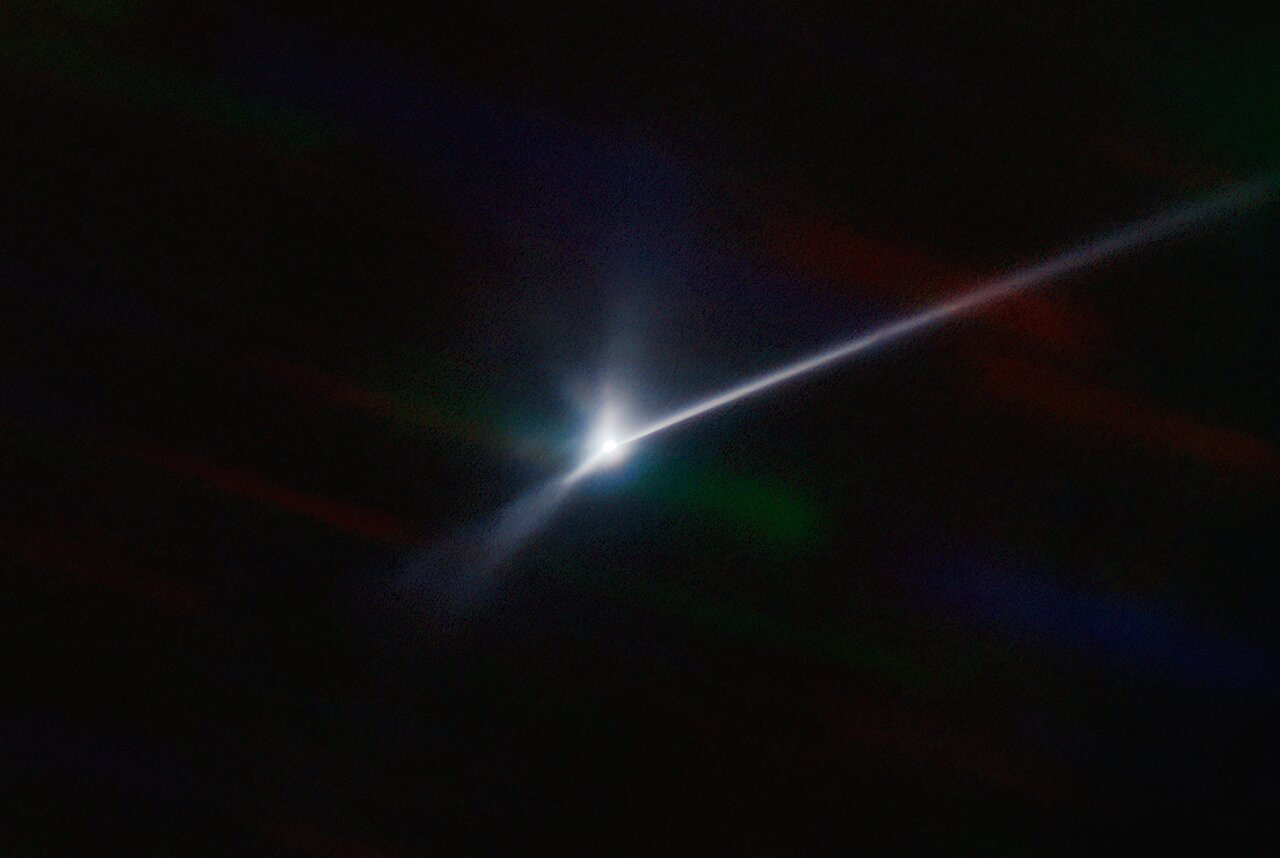 A telescope image shows the 10,000 km debris trail from a demonstration collision with an asteroid moonlet