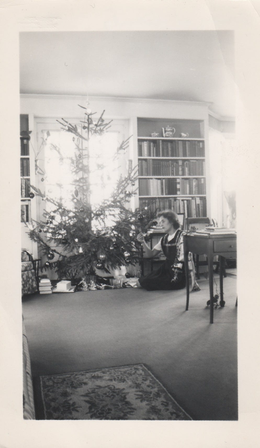 My grandma Maude at Riverby in front of the Christmas tree, a Norway Spruce, 1944