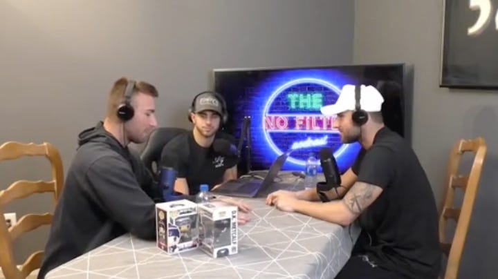 three white men sit around an ugly kitchen table