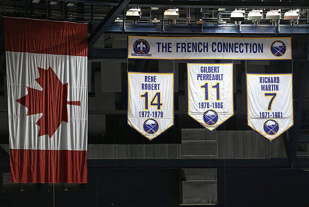 Banners of the French Connection Rene Robert of the Buffalo Sabres and Gilbert Perreault and Richard Martin hang from the rafters before the NHL game...