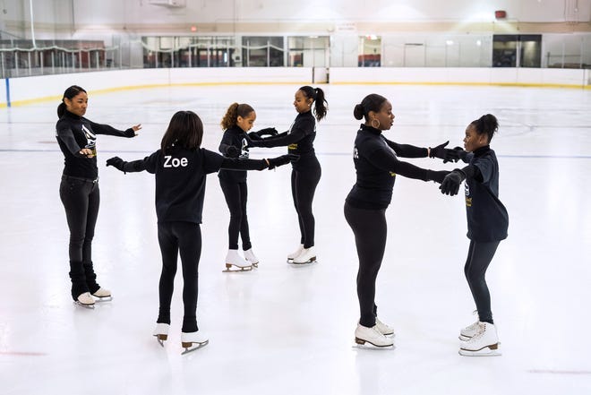 Dream Detroit Skating Academy coaches and co-founders help students with form while demonstrating the team ice skating at the Jack Adams Memorial Arena in Detroit on January 27, 2022, in advance of the grand opening of the first female Black-owned figure skating club in the State of Michigan and the only figure skating club in the city of Detroit.
