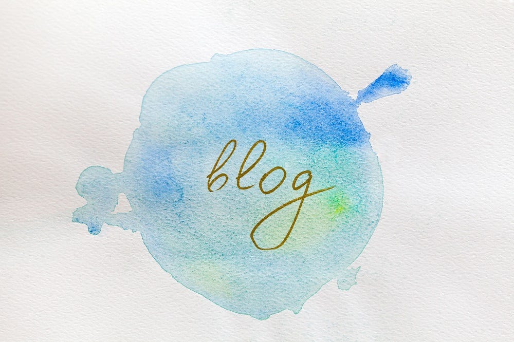 blog written on a blue paint splotch