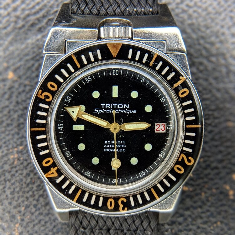 © WATCHISTRY | Spirotechnique was a diving equipment brand founded by Jacques Cousteau; its Triton watch was developed in the early 1960s to professional diving and military standards. This particular example was issued to the  RHIN , a submarine support vessel in service from 1964-2002; during a service, this Triton received a replacement Rolex crown.