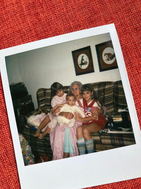 Polaroid of Robyn and her siblings sitting on their grandmother's lap on Christmas morning