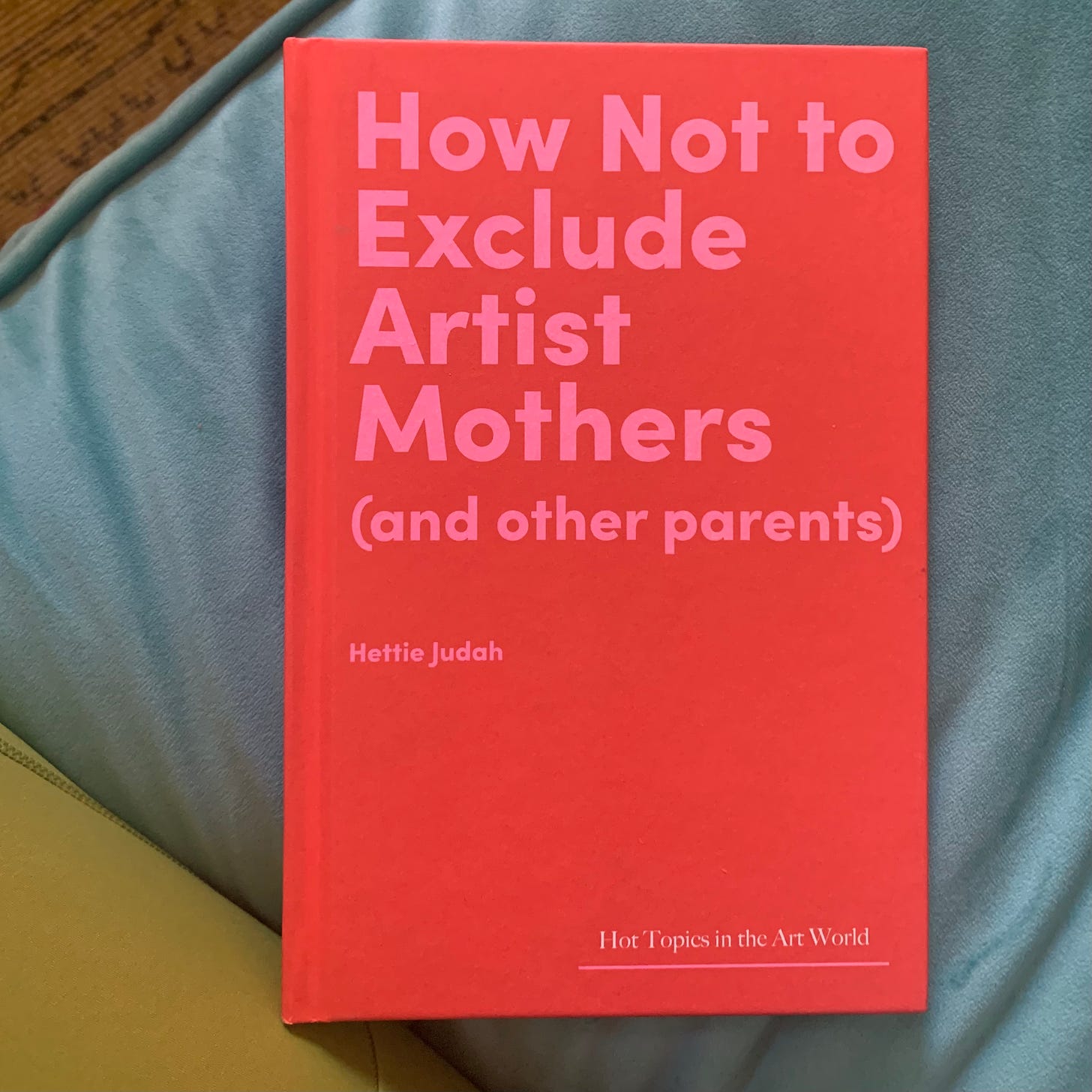 How Not To Exclude Artist Mothers (And Other People) by Hettie Judah, photo of red and pink book cover