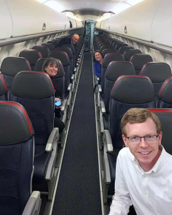 In this photo provided by Represenative Dusty Johnson, Johnson takes a selfie with House colleagues on a mostly empty plane on 27 March.