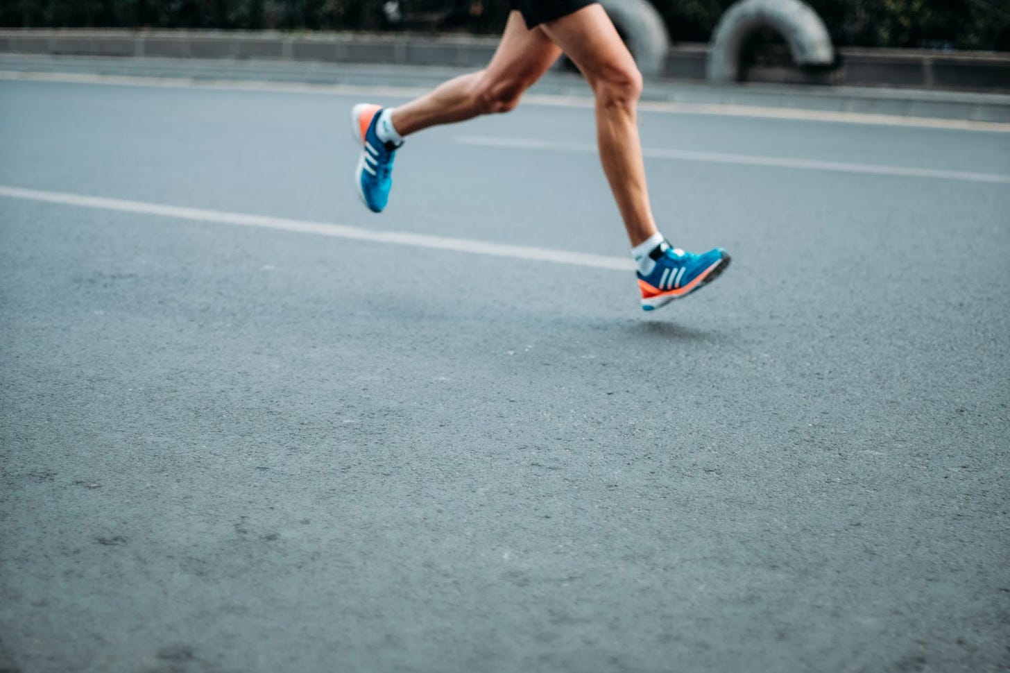 A man in running shoes speeds across the tack.