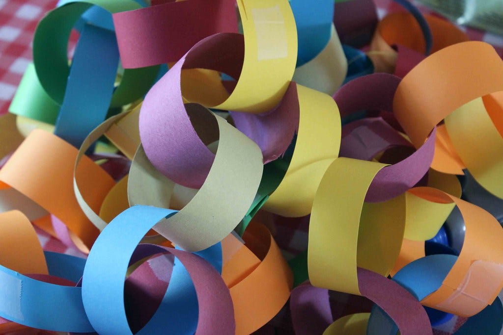 A mass of construction paper chains. "Paper Chains" by stitchlily is licensed under CC BY-NC-ND 2.0. 