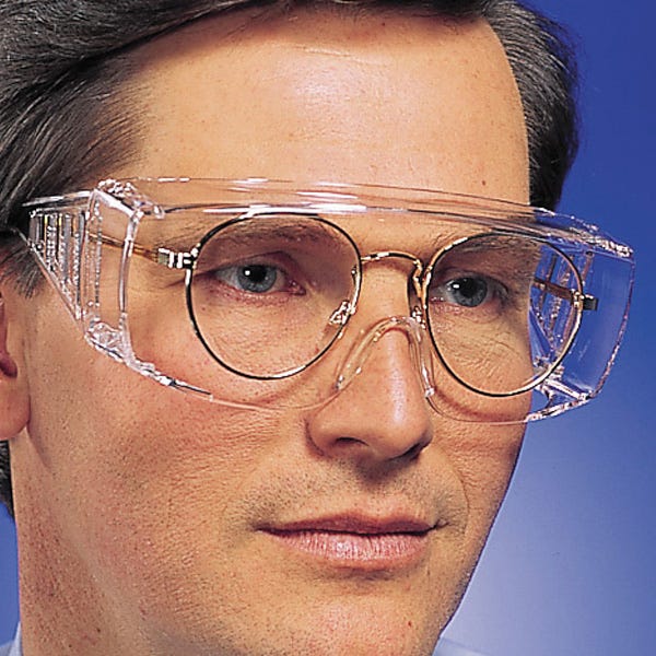 Photo of a man wearing safety glasses over his regular glasses. He seems at peace.