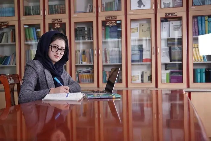 A person sitting at a table with a computer

Description automatically generated with medium confidence