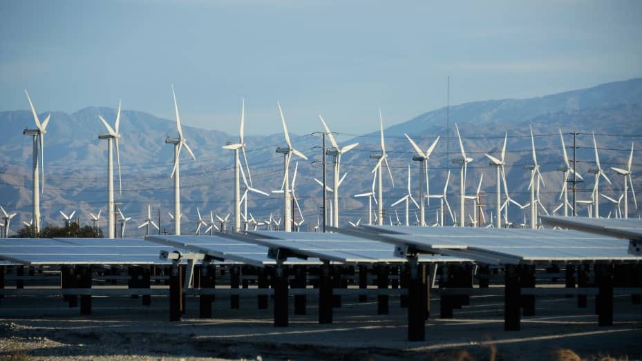 PALM SPRINGS, CA - MARCH 27:  Giant wind turbines are powered by strong winds in front of solar panels on March 27, 2013 in Palm Springs, California. According to reports, California continues to lead the nation in green technology and has the lowest greenhouse gas emissions per capita, even with a growing economy and population.  (Photo by Kevork Djansezian/Getty Images)